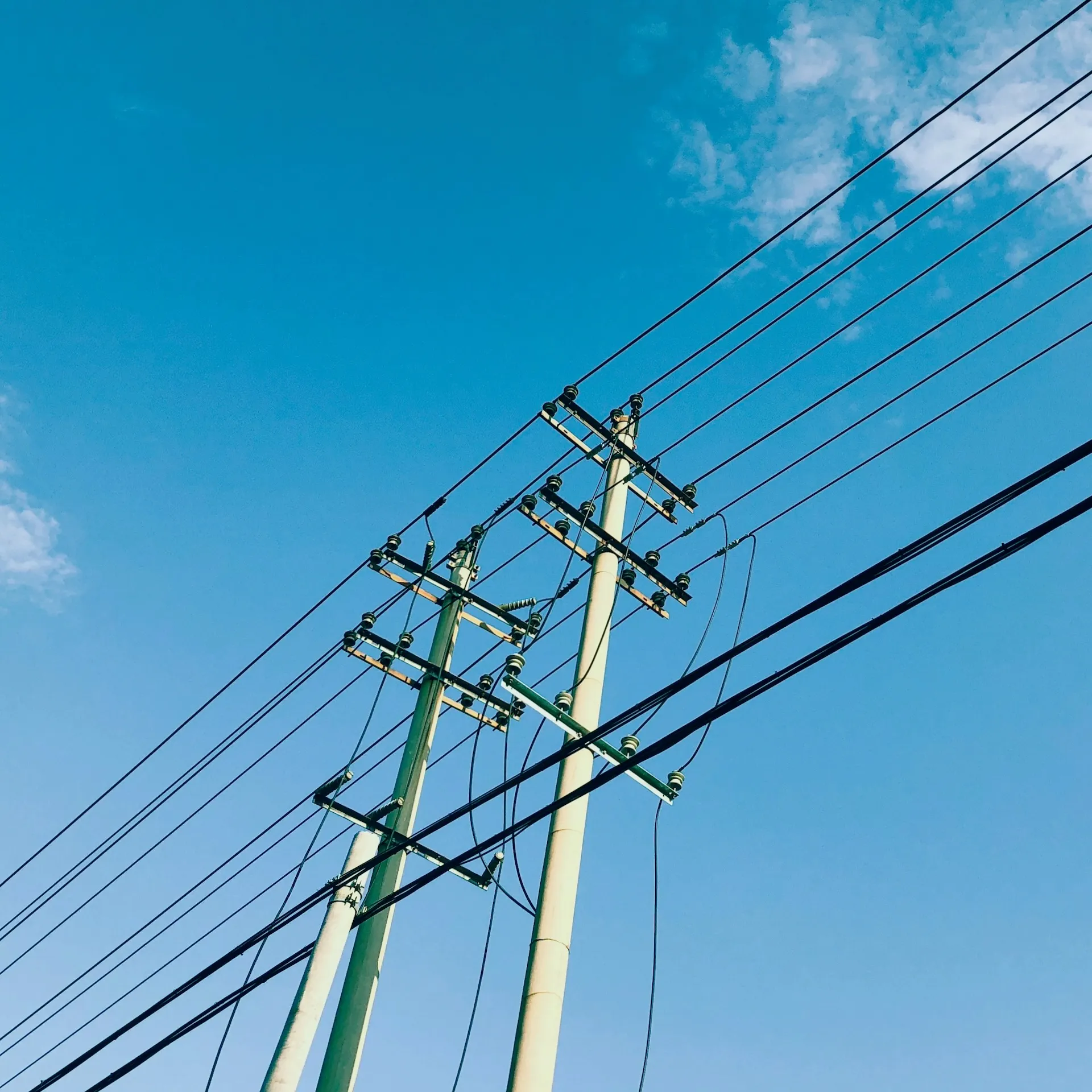 Photo by <a href="https://unsplash.com/@yinji_f?utm_source=unsplash&utm_medium=referral&utm_content=creditCopyText">Yin Fang</a> on <a href="https://unsplash.com/photos/power-lines-and-telephone-poles-against-a-blue-sky-u-dsCdJv45I?utm_source=unsplash&utm_medium=referral&utm_content=creditCopyText">Unsplash</a>